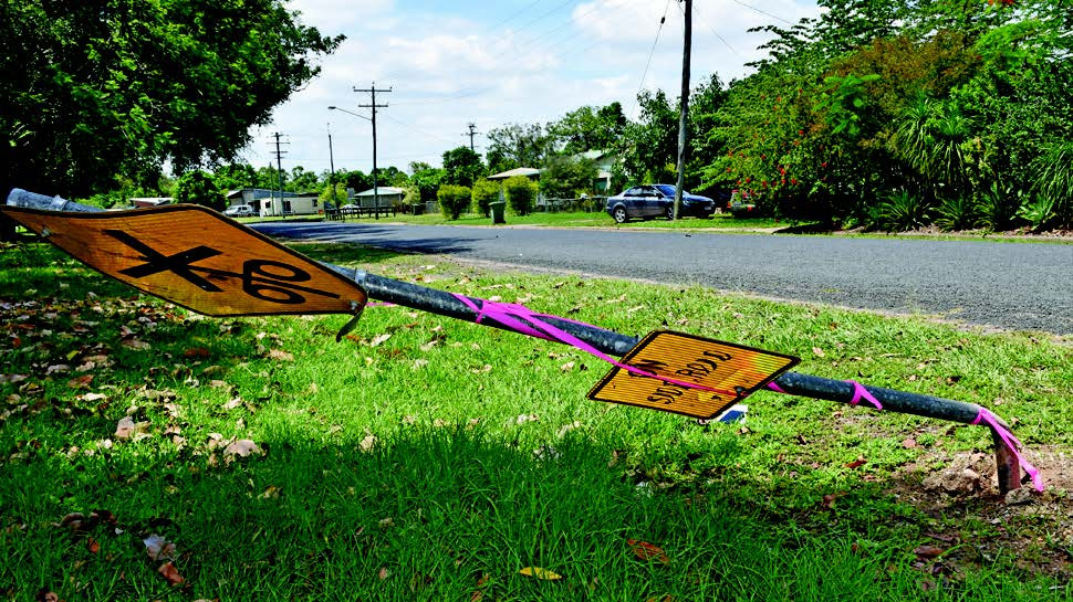 The damaged sign which has been hit by a vehicle.