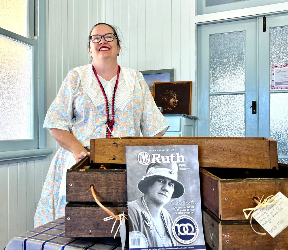 Natalie Curtis with the old hall fl oor boards that were turned into trays after the renovation.