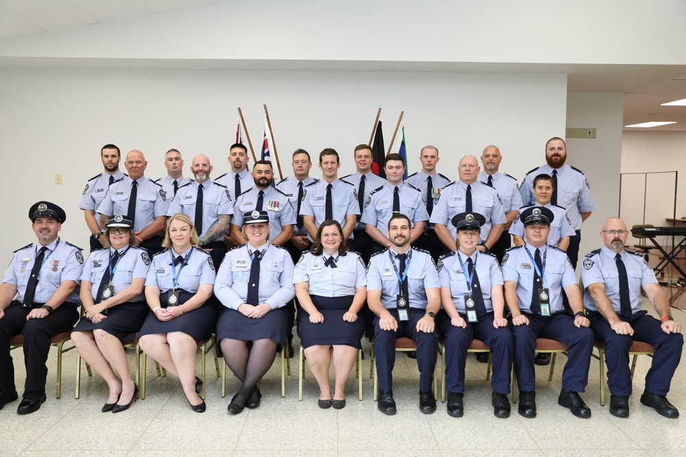 Graduates (back rows) with QCS training coordinator Carmelo Salerno, Community Corrections Regional Manager Northern Region Nicole Duke, Assistant Commissioner Southern Region Command Ursula Roeder, Lotus Glen Correctional Centre general manager Gabrielle Payne, Acting Assistant Commissioner Eloise Hamlett, district manager Geoffrey Robins, Operational trainers Linda Roy and Michael Morrison and Parade Commander Terry O’Brien.