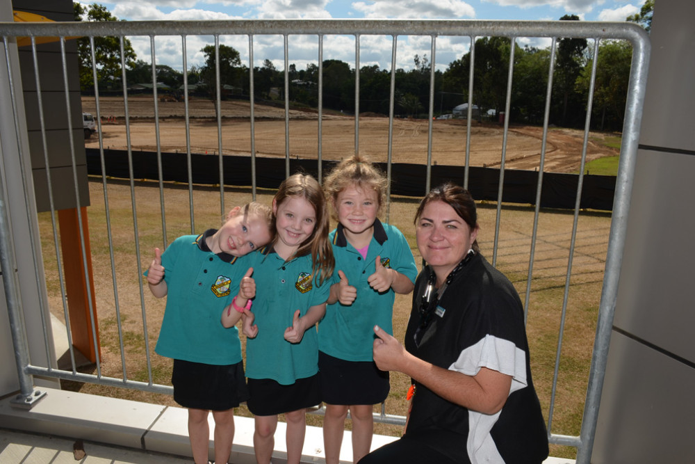 Grade 1 students Dixie Di Cola, Mia Winters and Jade Donahue with principal Hannah Simpson watching the works being done to Brady Park.