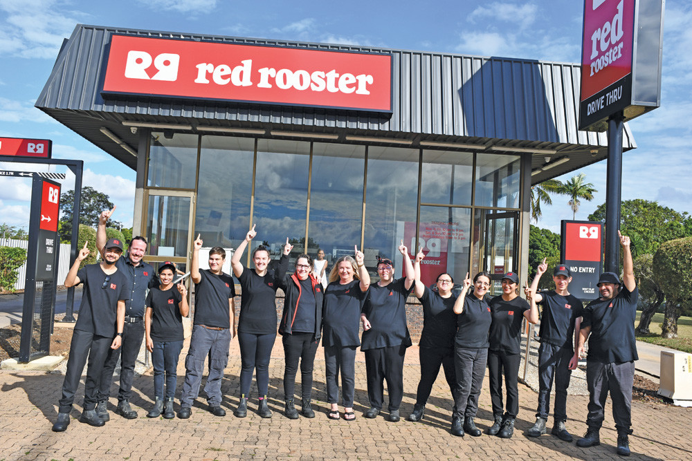 Staff celebrate the changes at Mareeba’s Red Rooster store after managing director Peter Walsh (second from left) invested in a major makeover for the shop.