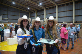 Rodeo Queen entrants Caitlyn Parsons (left), Mia Phillips and Sallie Kaczmarek offered drinks and nibbles to the attendees.