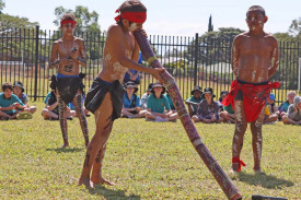 A young student shows off his digeridoo skills.