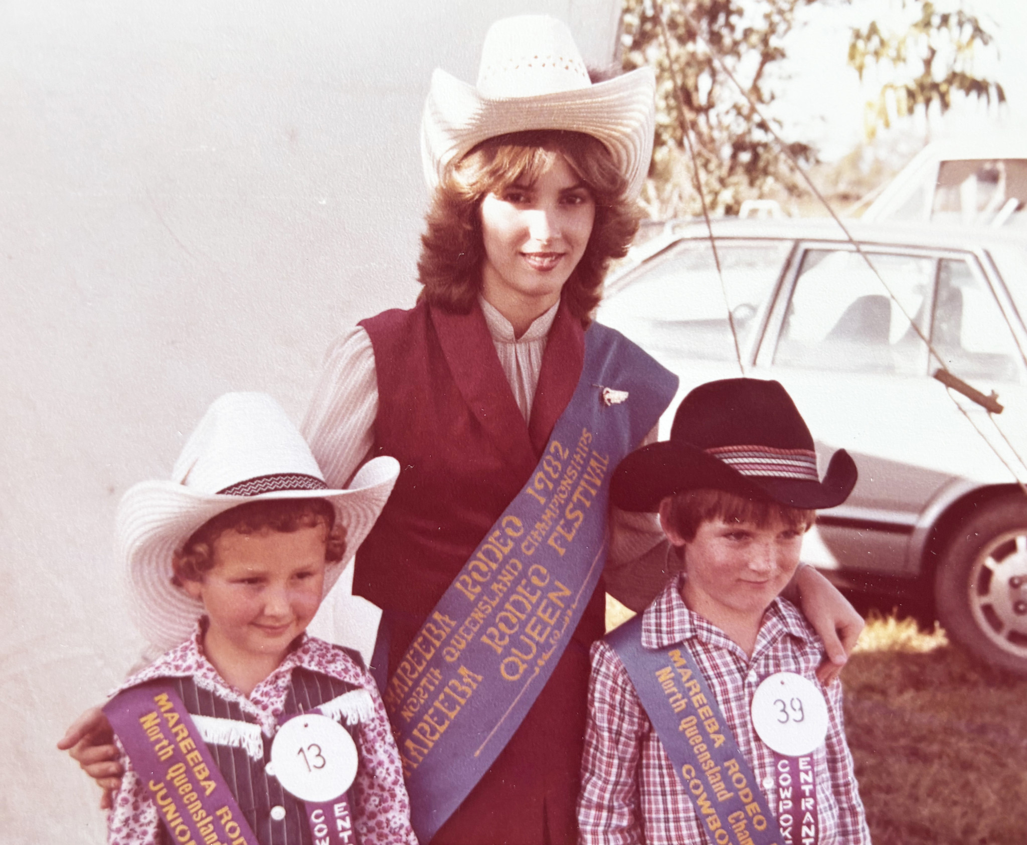 1982 Mareeba Rodeo Queen Kim Aqulina with the winners of the 1983 Cowpokes competition.