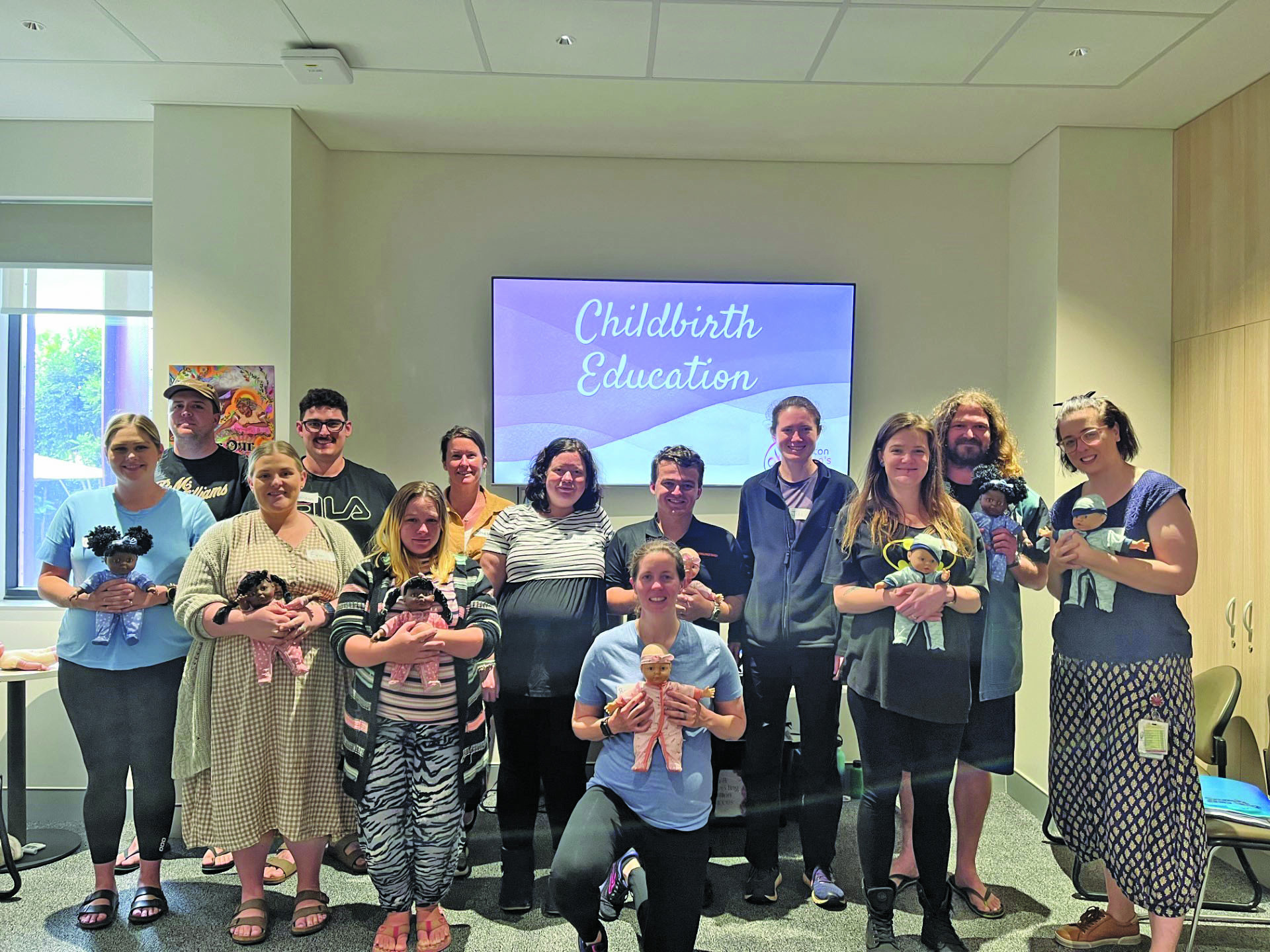 Midwife Caitlin Troy (right) with the returned antenatal class attendees.