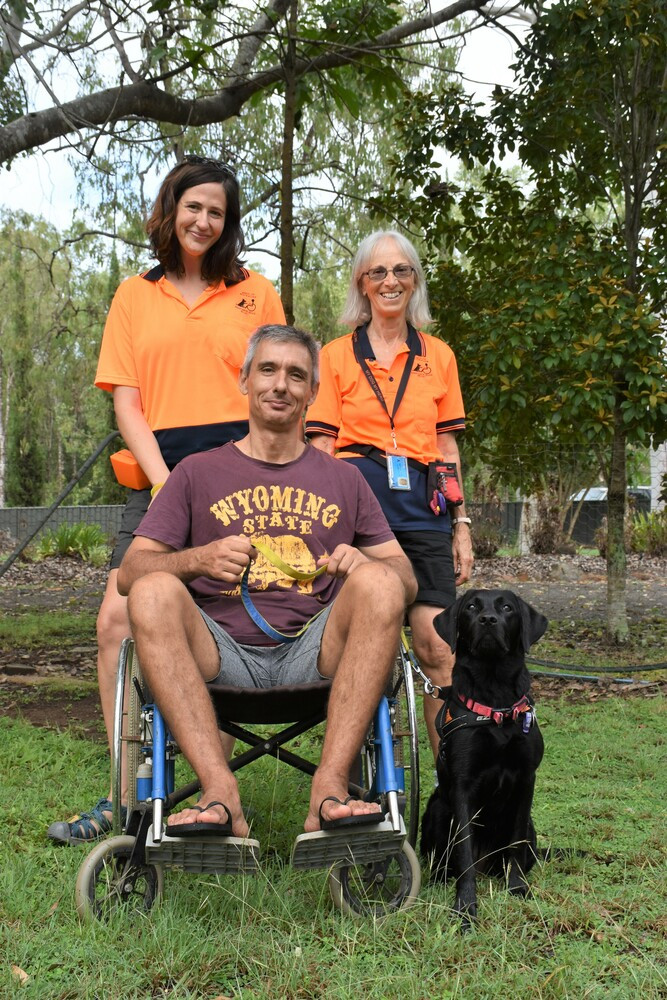 Trainers Carly Starr and Ann Pierson with carer Tony Vlahovic with six month old assistant dog in training Lily.