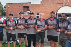 Members of the Atherton Roosters Rugby League Club attend the candle lighting event.