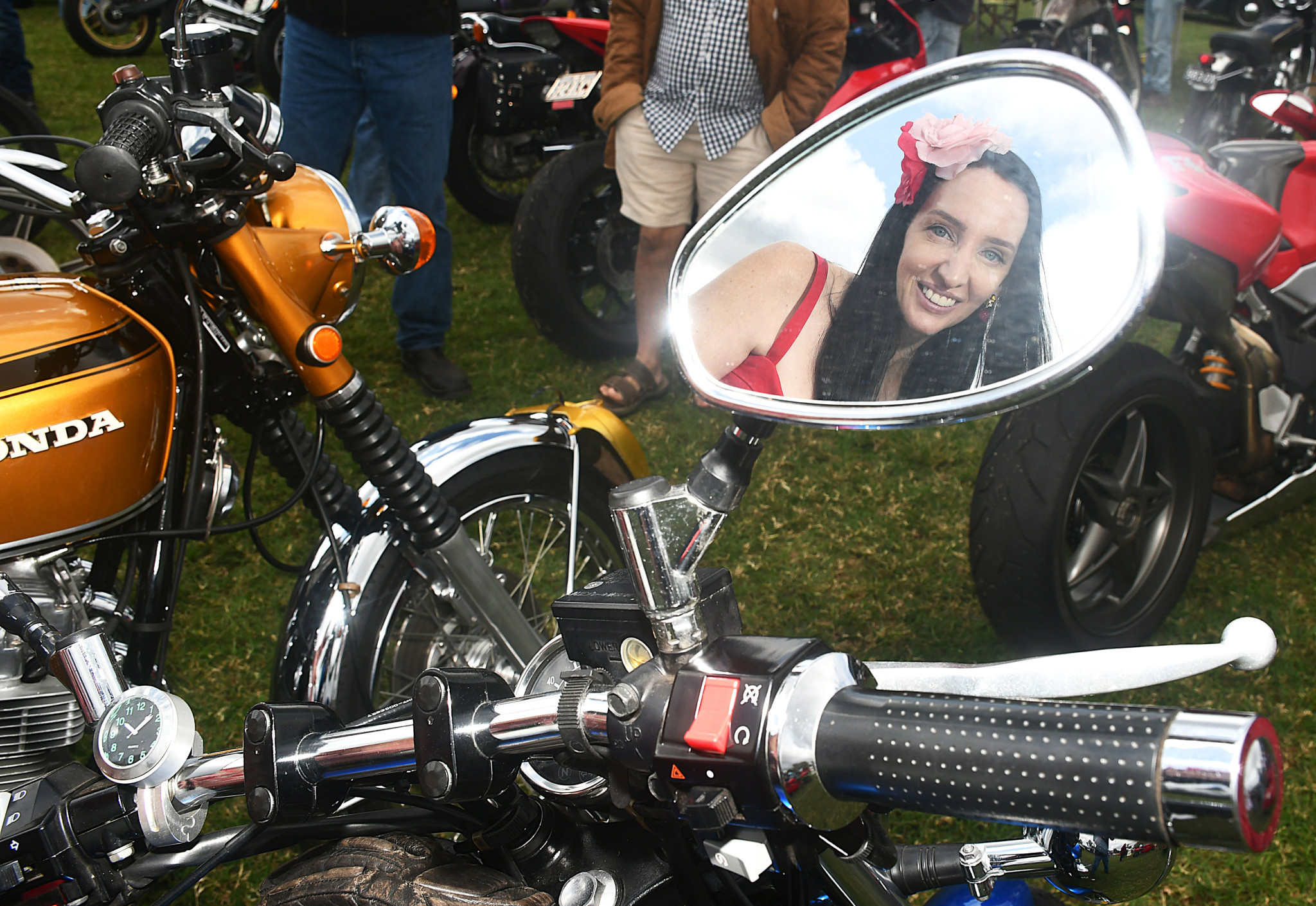 Sarah Parnell reflected in the side mirror of one of the bikes on display.