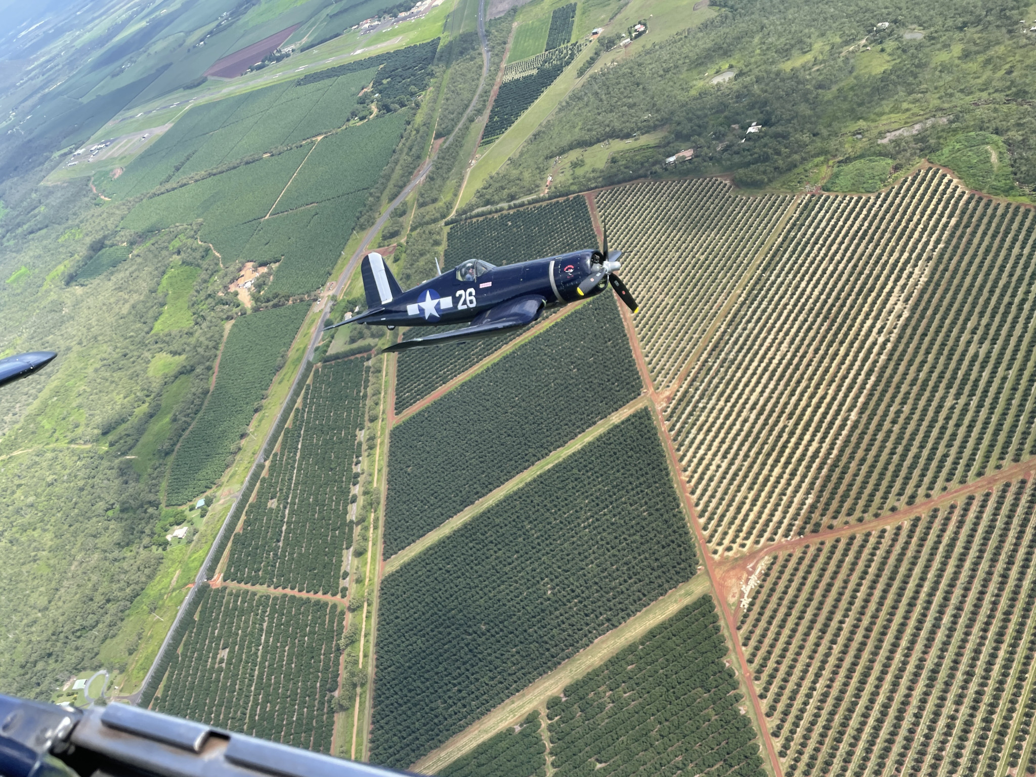 The Corsair during a flight above the farming lands over Mareeba. The brilliant blue Corsair is a WWII plane that was in the Battle of Okinawa during the end of the war and defeated its enemies with ease.