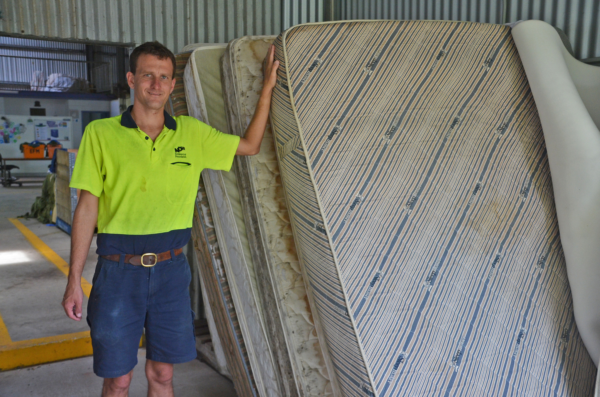 Denis Pecotic with the used mattresses that the company dismantles for recycling.