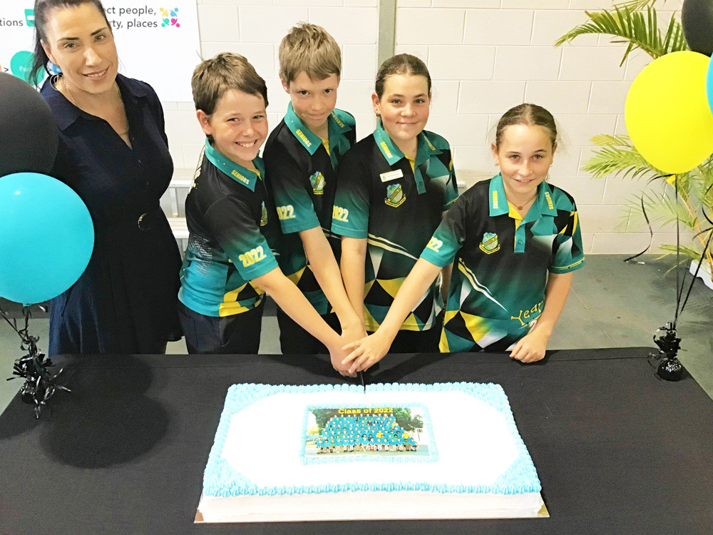 Mareeba State School leaders Zebedee Knighton, Mitchell Gale, Kahlia Sellers and Aimee Fink cut the cake to celebrate the end of their primary school years.
