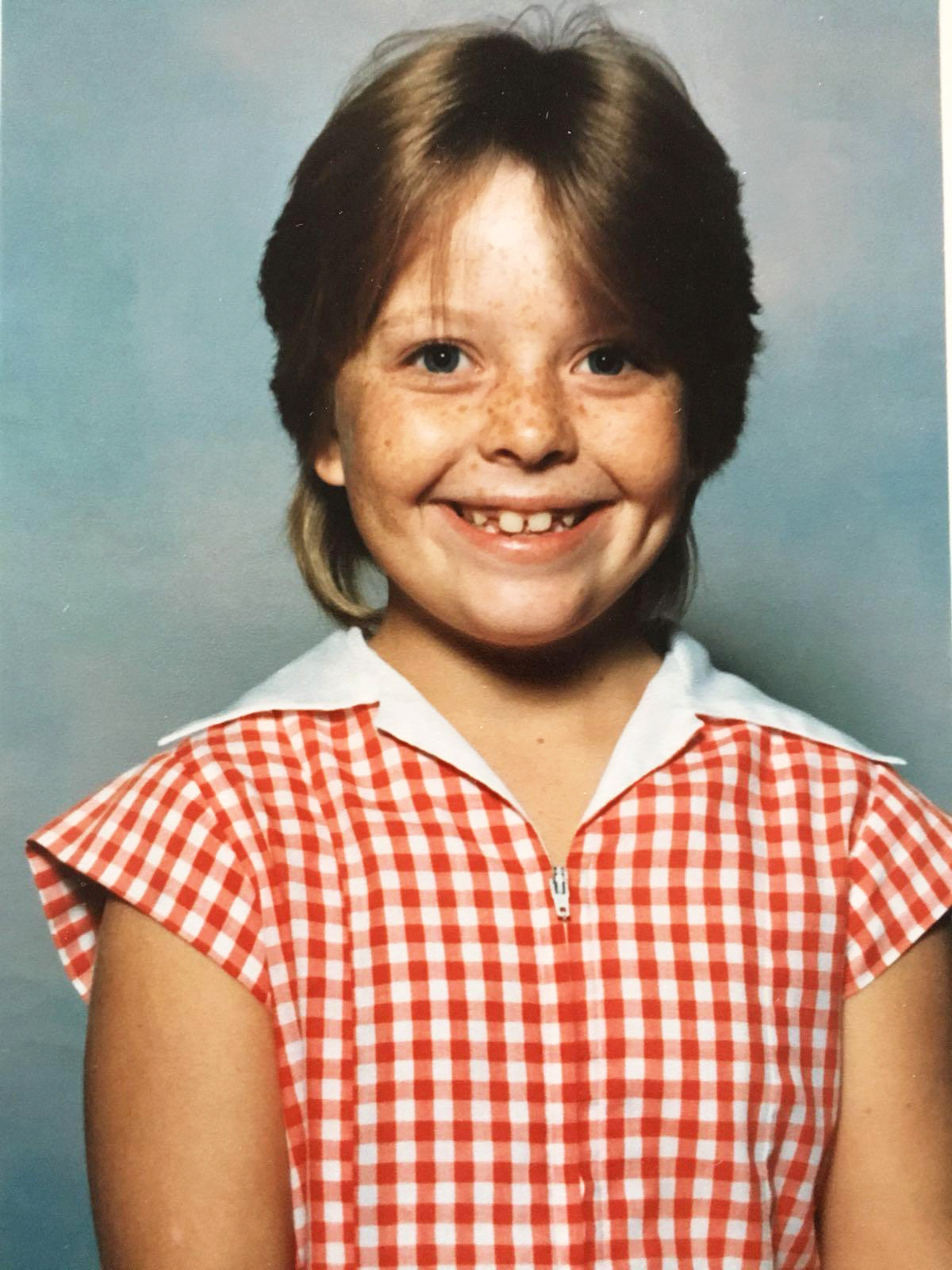 Juliet in her St Thomas’ school uniform during her childhood in Mareeba.