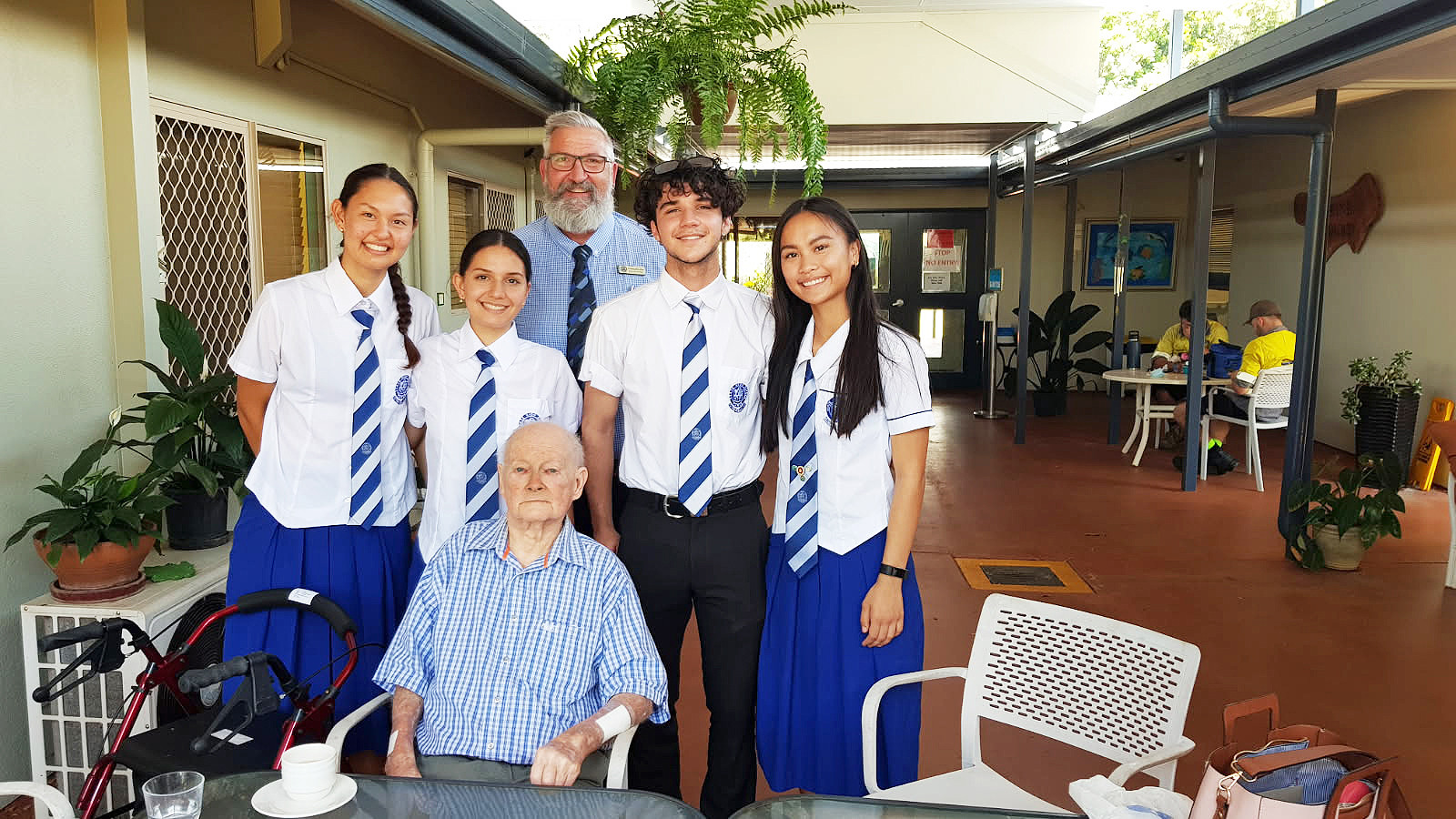Students from Cairns State High School, along with former principal Chris Zilm, visited Ken at Ozcare in Malanda.