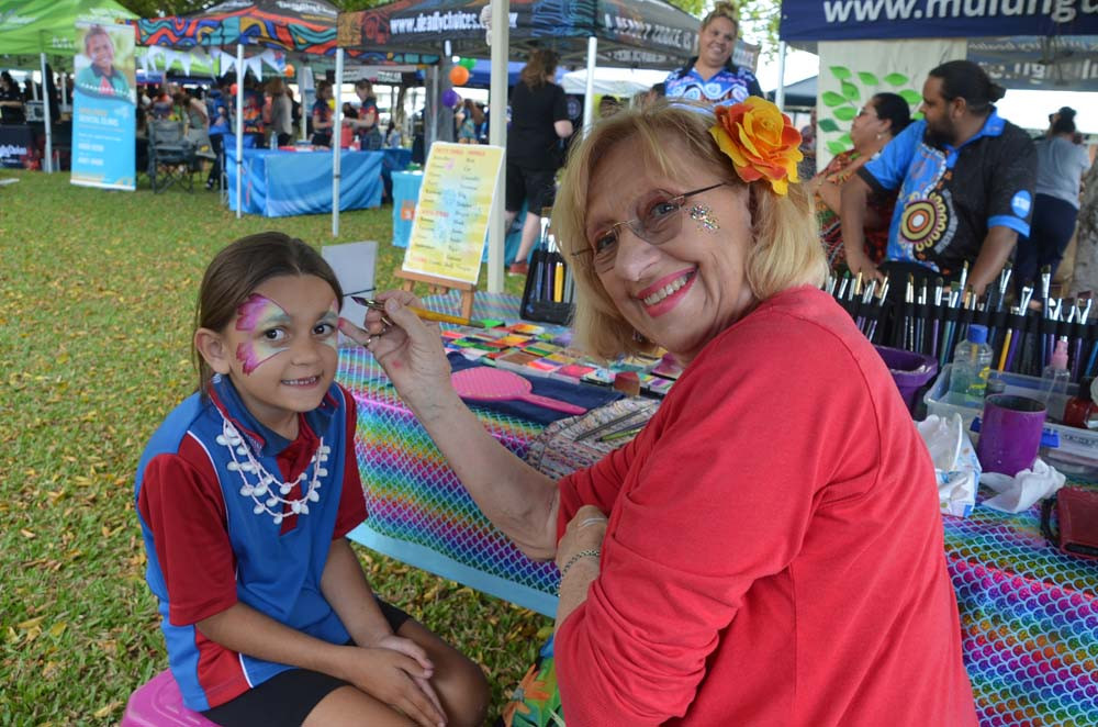 Nikki the Clown creates butterfly wings on six-year-old Avie Dwyer.