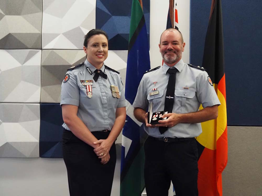 Atherton Paramedic Andrew Wilson receiving his 15-year National Medal.