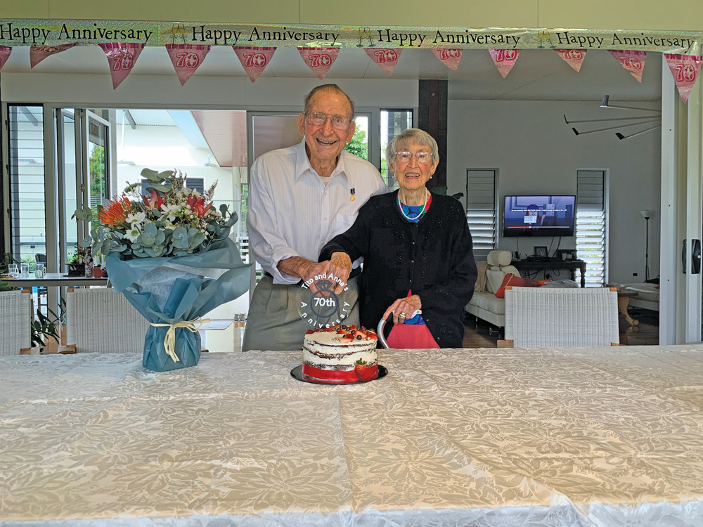 Tito and Anna celebrating their anniversary with a cake.