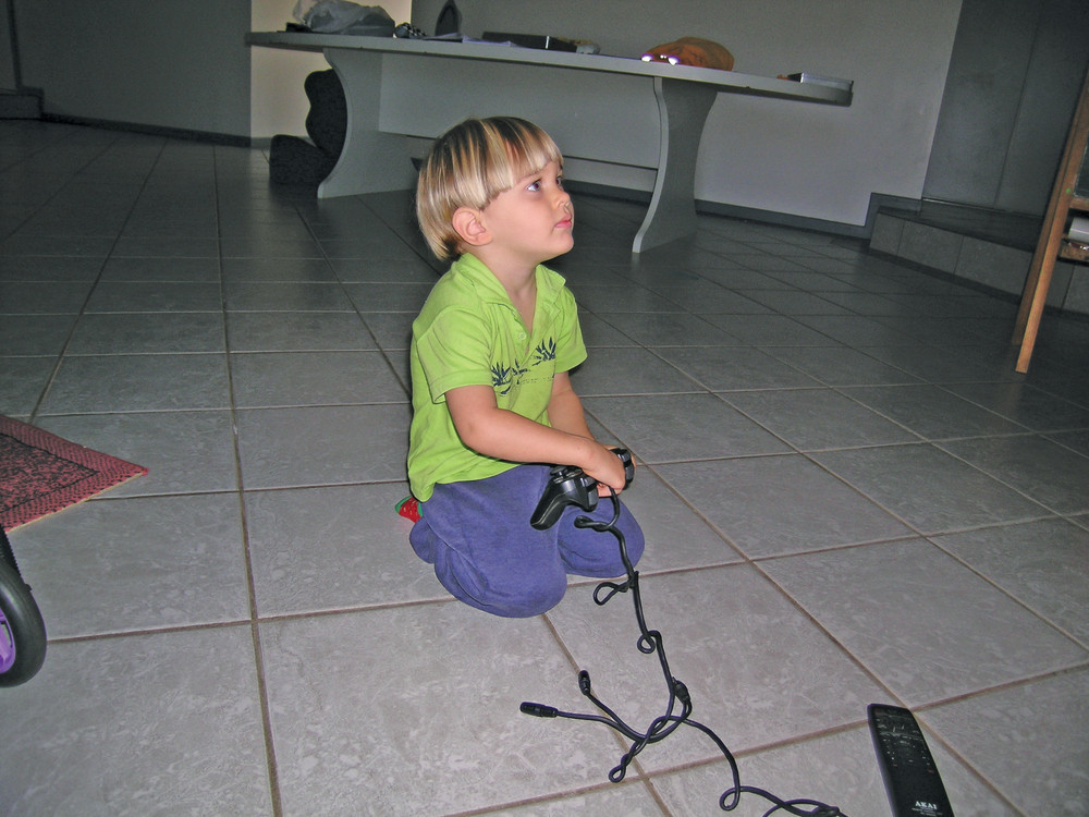 Kyle got into gaming as early as two years old, pictured here on the floor of the living room playing the early Playstation. (Photo Provided)