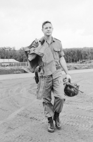 Helicopter pilot, Second Lieutenant Barry Dick strides toward his chopper to complete another flying mission in Nui Dat, South Vietnam in October 1969.