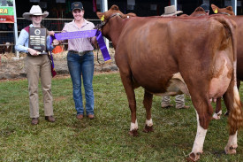 Dairymaid Harmonie Tidcombe assists Rachel English as she exhibits the English family’s Eachamvale Precious 7 - the Supreme Udder & Supreme Champion Dairy Cow of the show. (Picture by Anne Daley)