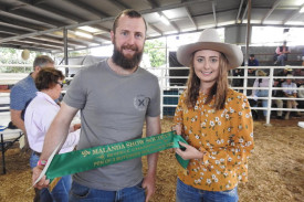 Gordon Carcary receives the Reserve Champion Pen of Three Butchers Bullocks ribbon from Rural Ambassador, Rikki Payne. (Picture Hide and Horns Photography)