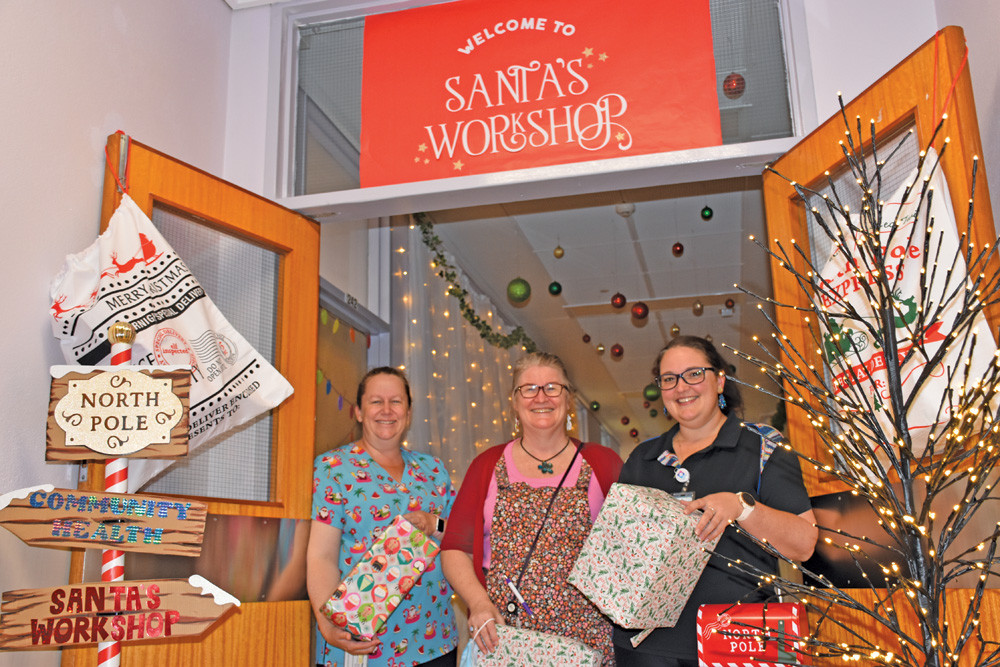 Mareeba maternity ward staff members Trudy Peters, Sandy Cochrane and Kayla Taylor with the start of the ward’s Santa’s workshop display