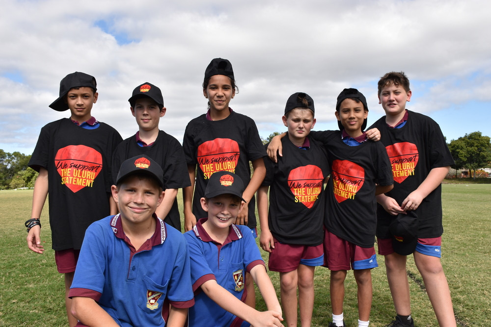 The free merchandise surrounding the Uluru Statement was a hit with students like Kobe and Nash (front), Mase, Roman, Tahani, Garry, Jai and Konway.