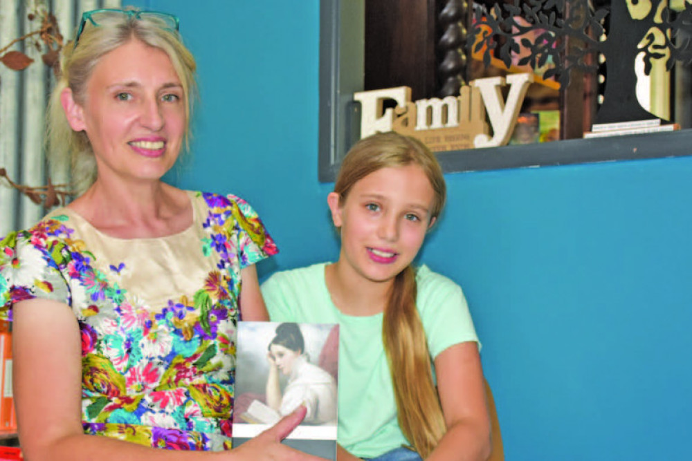 Kath Horton with her daughter and little helper Abigail inside the new Under Blue Skies bookshop in Mareeba.