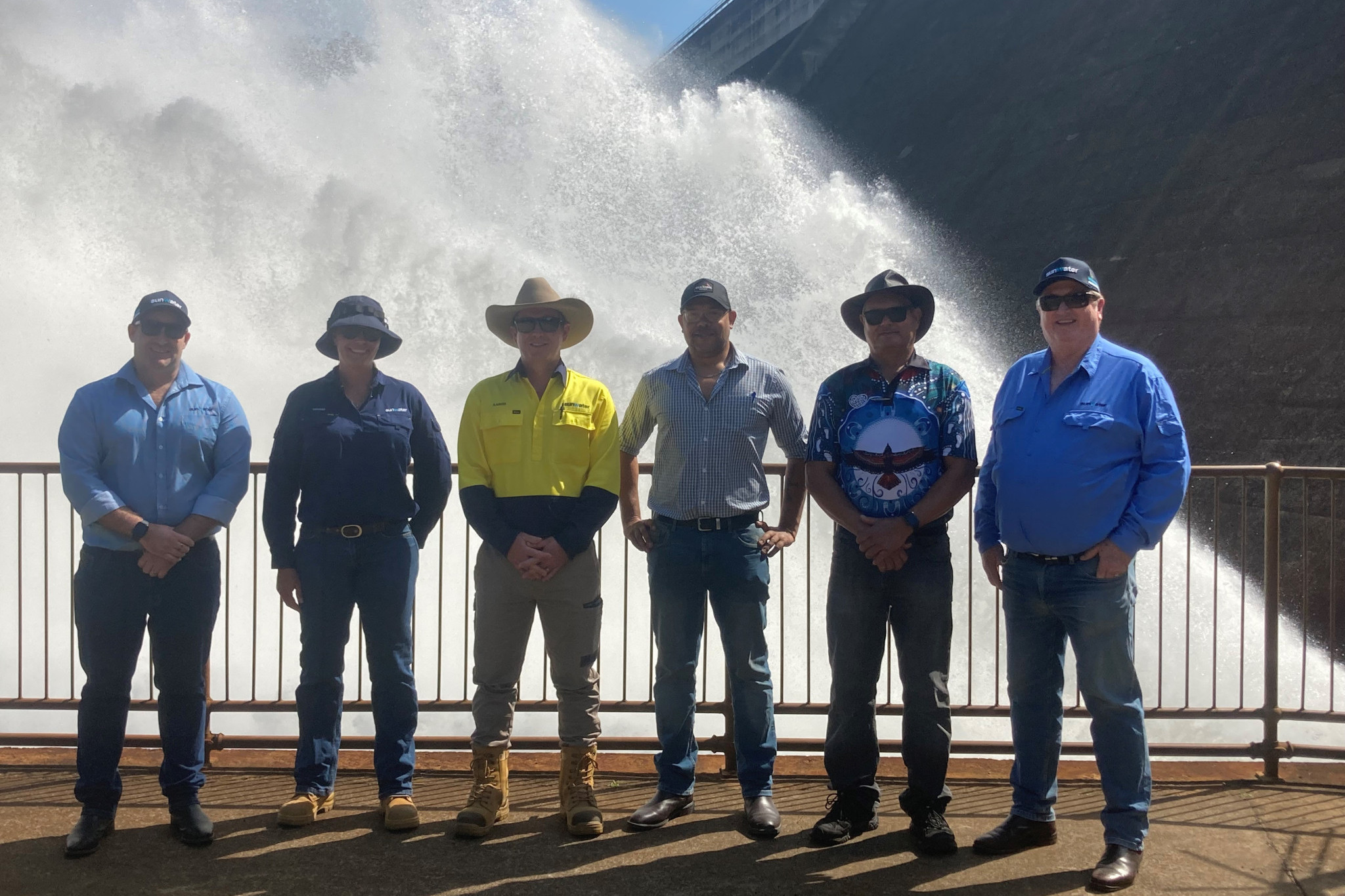 Andrew Cooper, Sunwater operations manager for the Far North Andrew (far left) with some members of the Sunwater team in front of Tinaroo Falls dam.