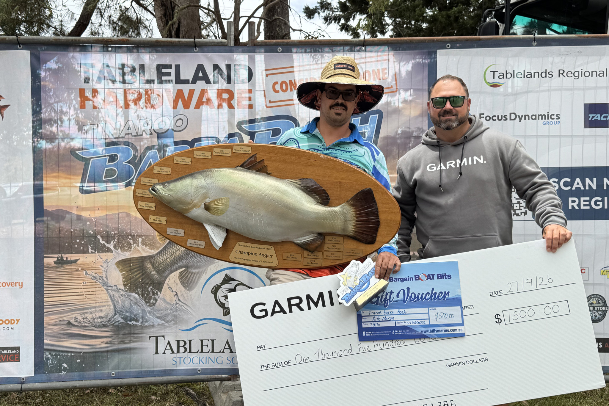 Champion Angler (Non-Livescope) and Largest Barra (Adult) winner, Seth McCann (left), is presented with his awards by Ben Weston from Garmin.