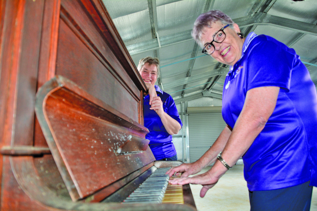 Atherton Friends president Di Williams and volunteer Bev Prescott playing the vintage Beale piano which is up for grabs.