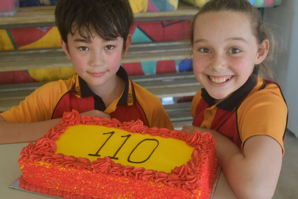 School captains Soloman Davidson and Amber Barnes with the anniversary cake.