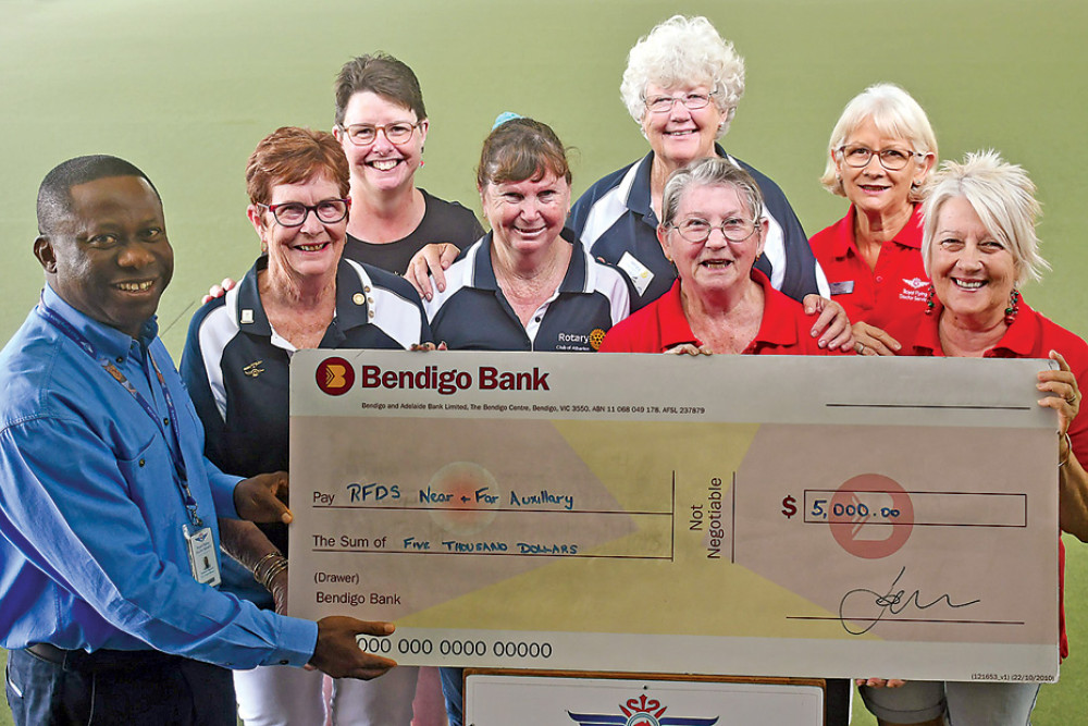 RFDS Cairns Base Manager Samuel Okposin receiving the Atherton Rotary $5000 cheque by rotary members Pauline Spackman, Glenda Smith and Leigh Woltman, and Auxiliary members Lorna Lavaring (back left), Brenda Agius, Cheryl O’Keefe and Susanne Gane.