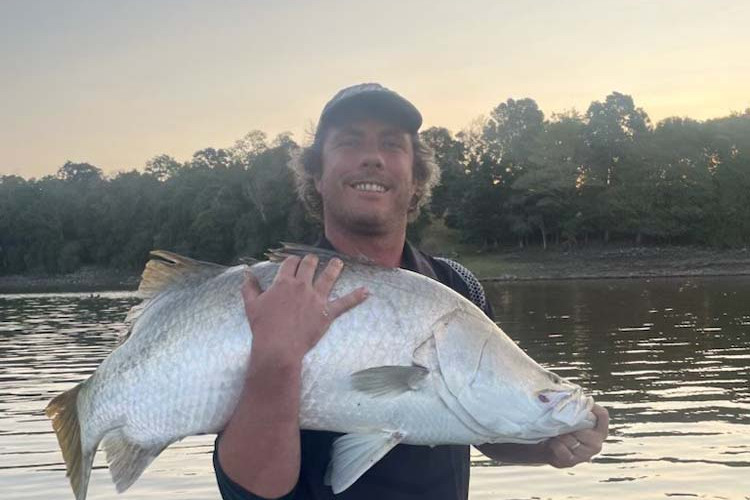 Cory Woodgate with a barra he caught.