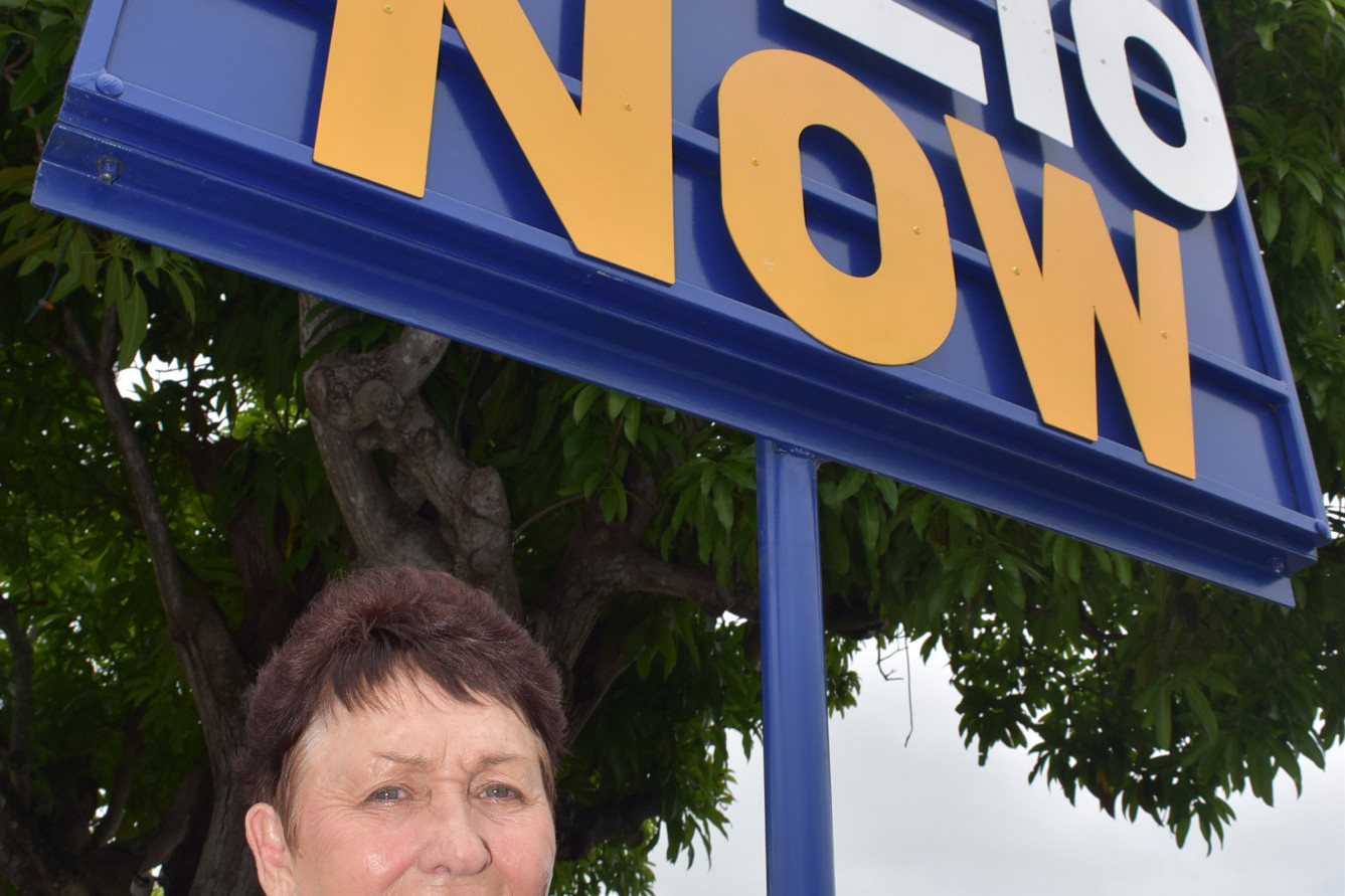 Polio survivor Carol Gear with the Mareeba Rotary’s ‘end polio now’ sign in Byrnes Street Mareeba which goes up in town every February to spread awareness of Polio.