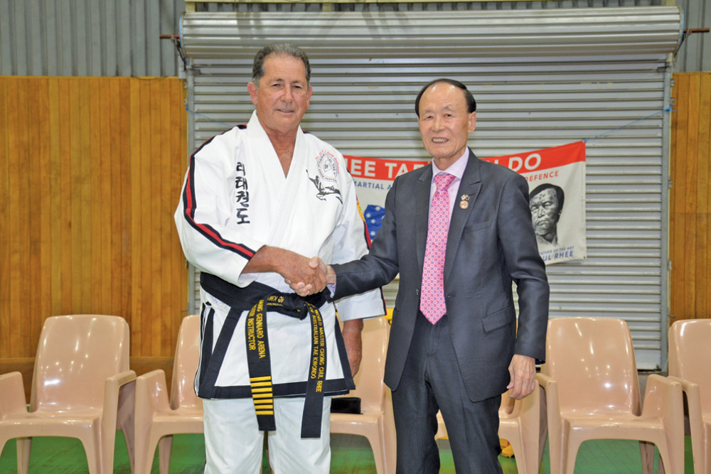 Mareeba Rhee Tae Kwon-do master instructor Gennaro Arena receiving his 7th Dan from Australia founder Master Chon Chul Rhee.