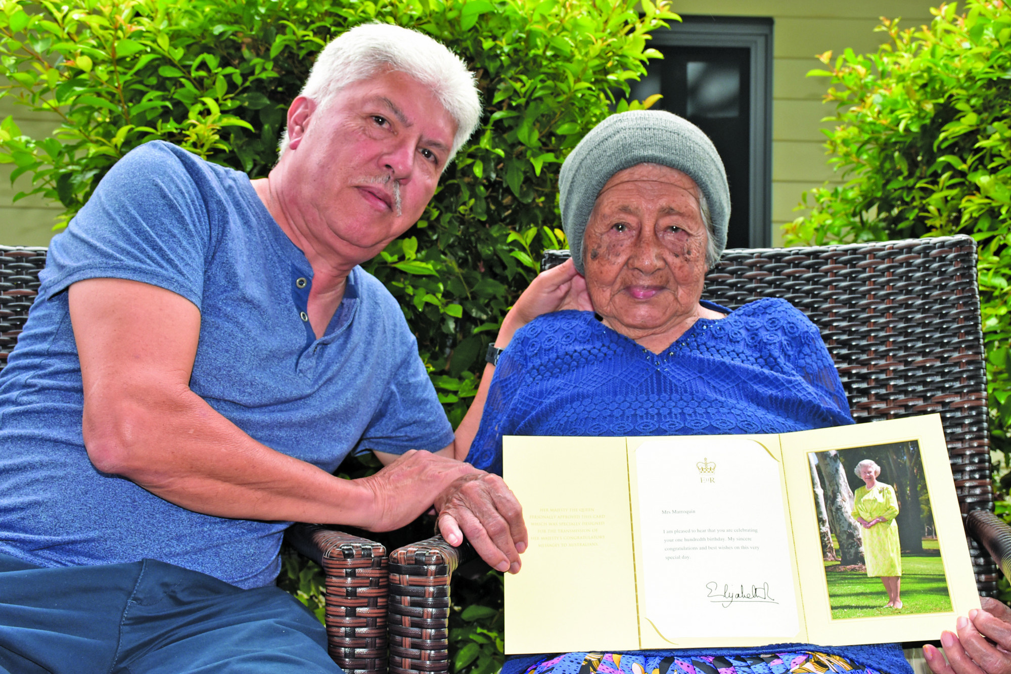 100TH BIRTHDAY: Oscar Alberto Marroquin with his 100 year old mother Maria Fabia Marroquin holding her letter from the Queen to celebrate her 100th birthday.