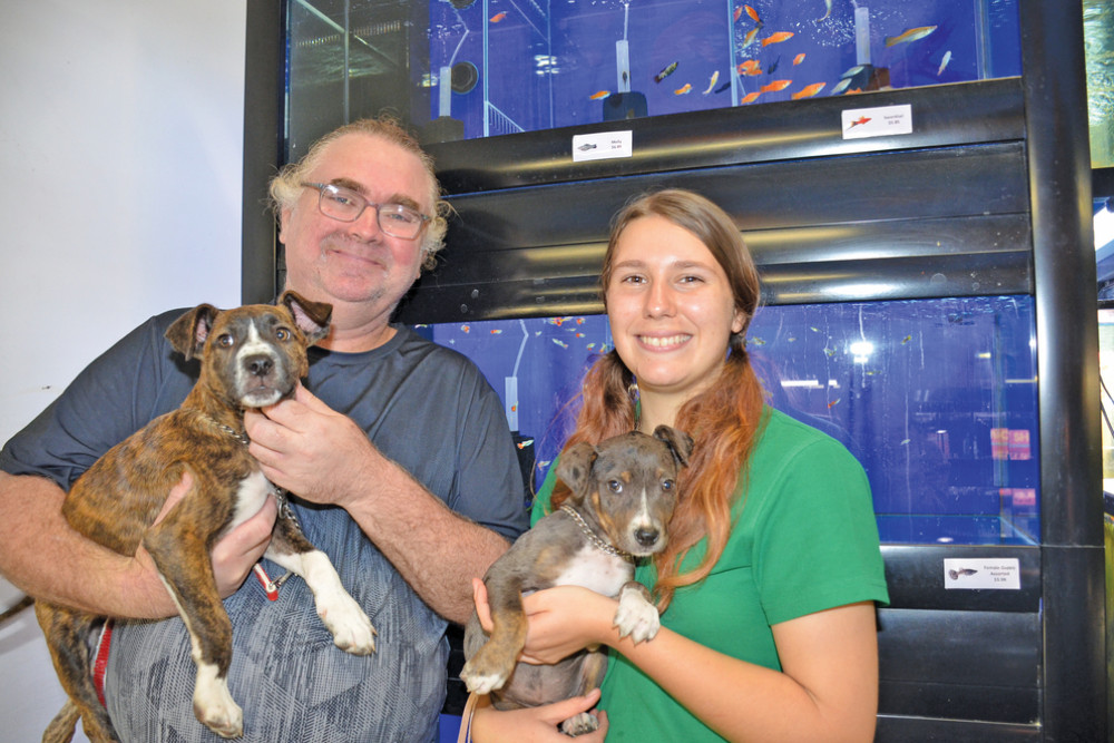 Fantasy Tail’s Bruce Hammond and Mareeba Animal Refuge’s Felicity Pollard with refuge pups Jared and Zac ready for their third adoption day.