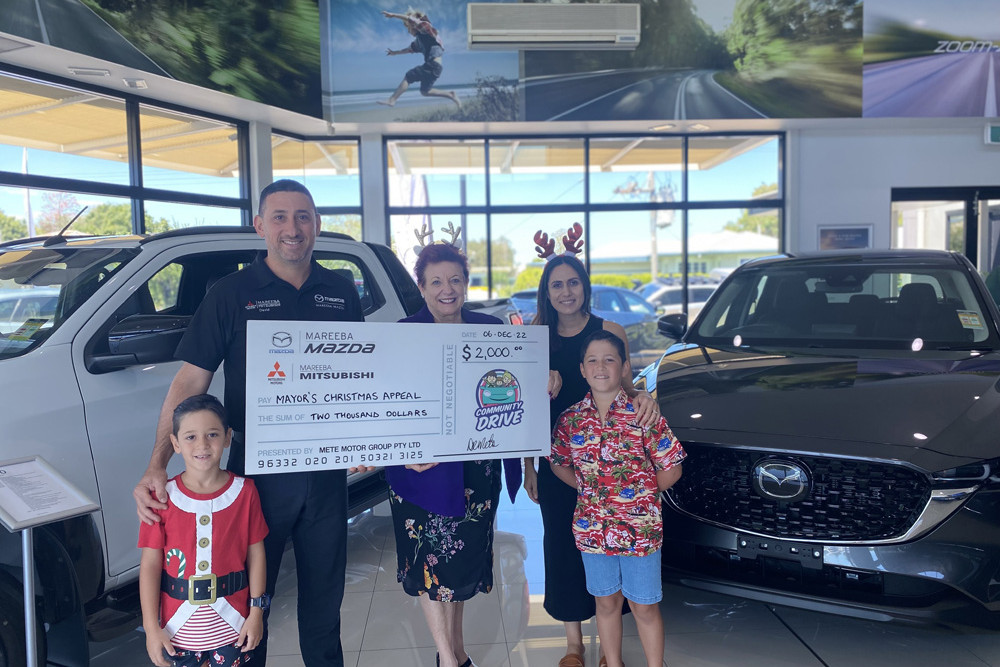 David and Jessica Mete of Mareeba Mazda and Mitsubishi with their children, Max and Cooper, present the donation to Mayor Toppin.