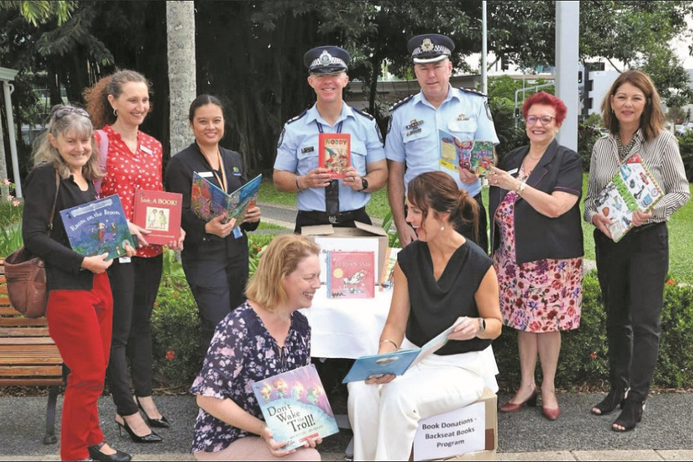 Senior Sergeant Marty Ots and A/Chief Superintendent Chris Hodgman with Mareeba Mayor Angela Toppin, and Cairns Cr Amy Eden supporting Backseat Books.