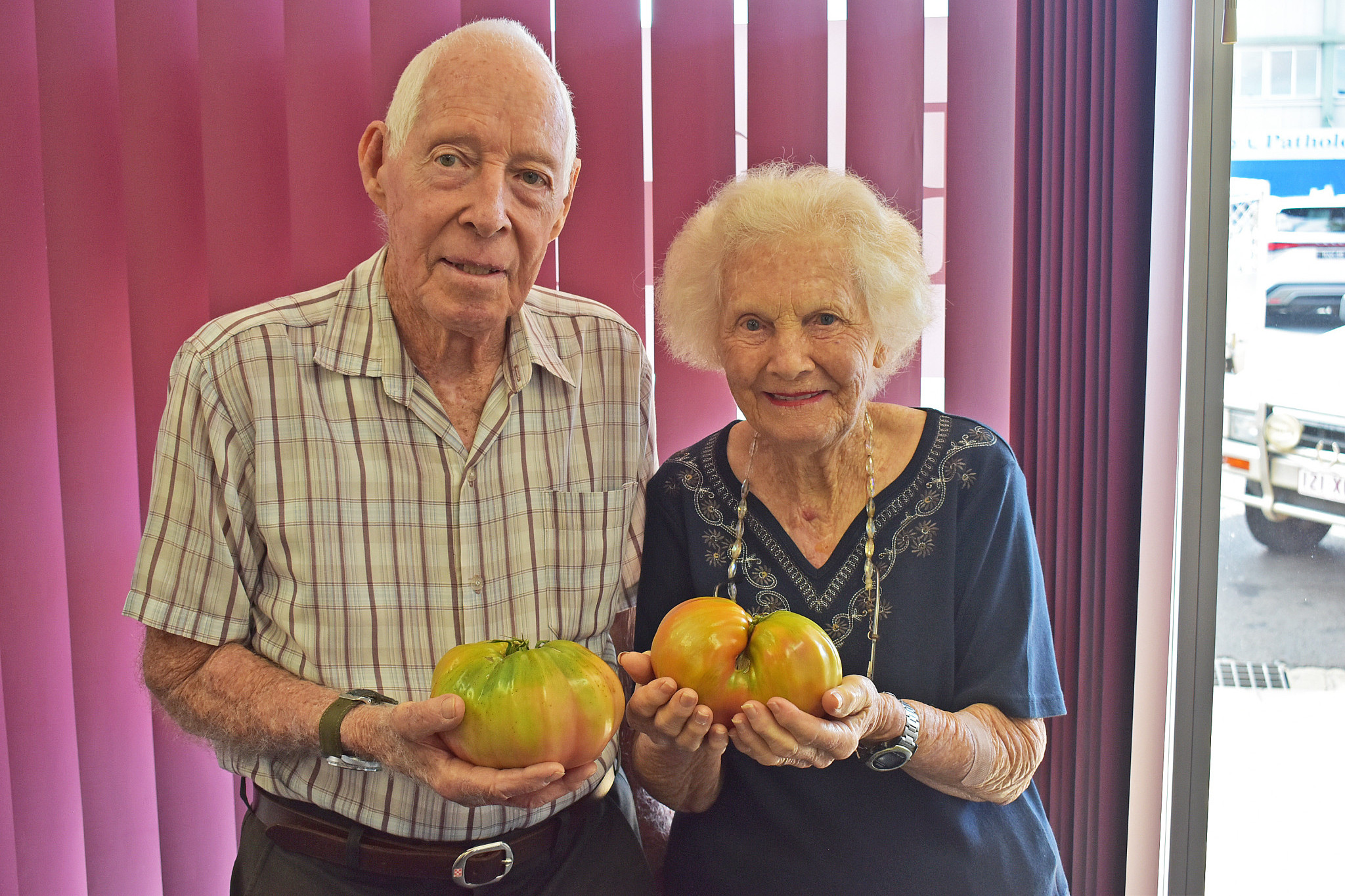 Mareeba locals Bill and Dorris Rockley have grown a pair of giant tomatoes.