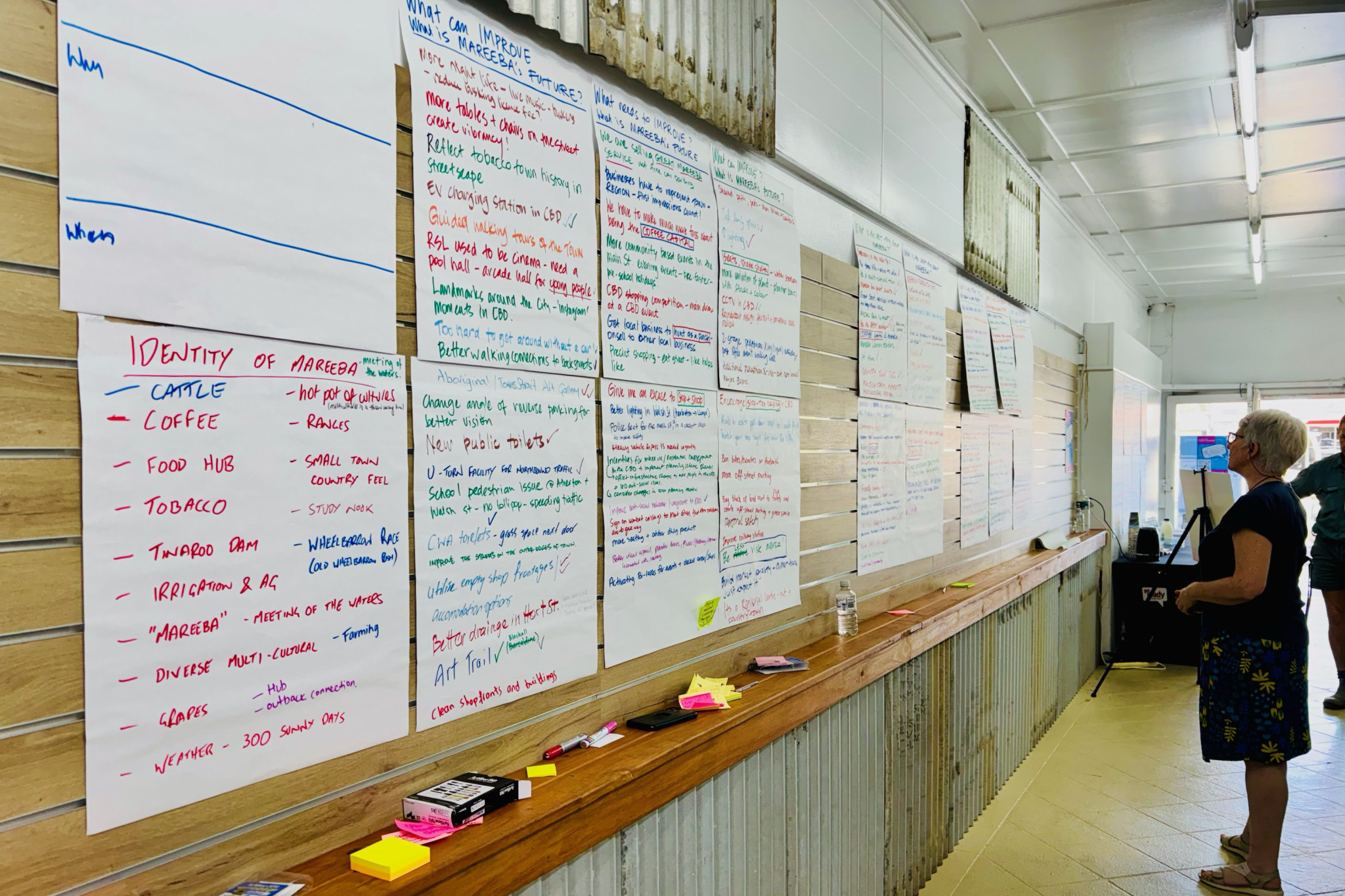 A local resident takes in the walls of comments at last week’s pop-up shop to get feedback on how to improve the CBD.