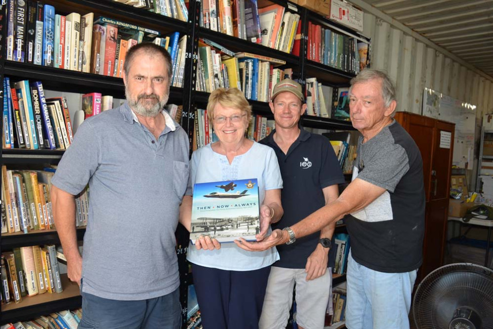 Members of the FNQ Aviation Museum Ian Whyte, Joan Stanton, Brendan Kent and Alan Martin accepting their donated book.