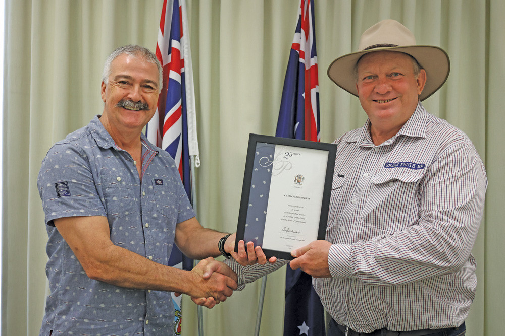 Member for Hill Shane Knuth presenting Dimbulah senior paramedic Charles Khan with his 25-year certificate for his service as a Justice of the Peace.