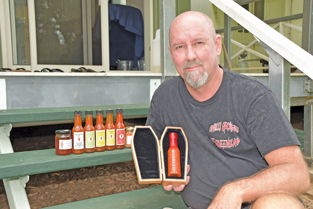 Jamie McConnachie with a selection of his different chilli-based products including the newly released Deathly Hot Coffin Brew