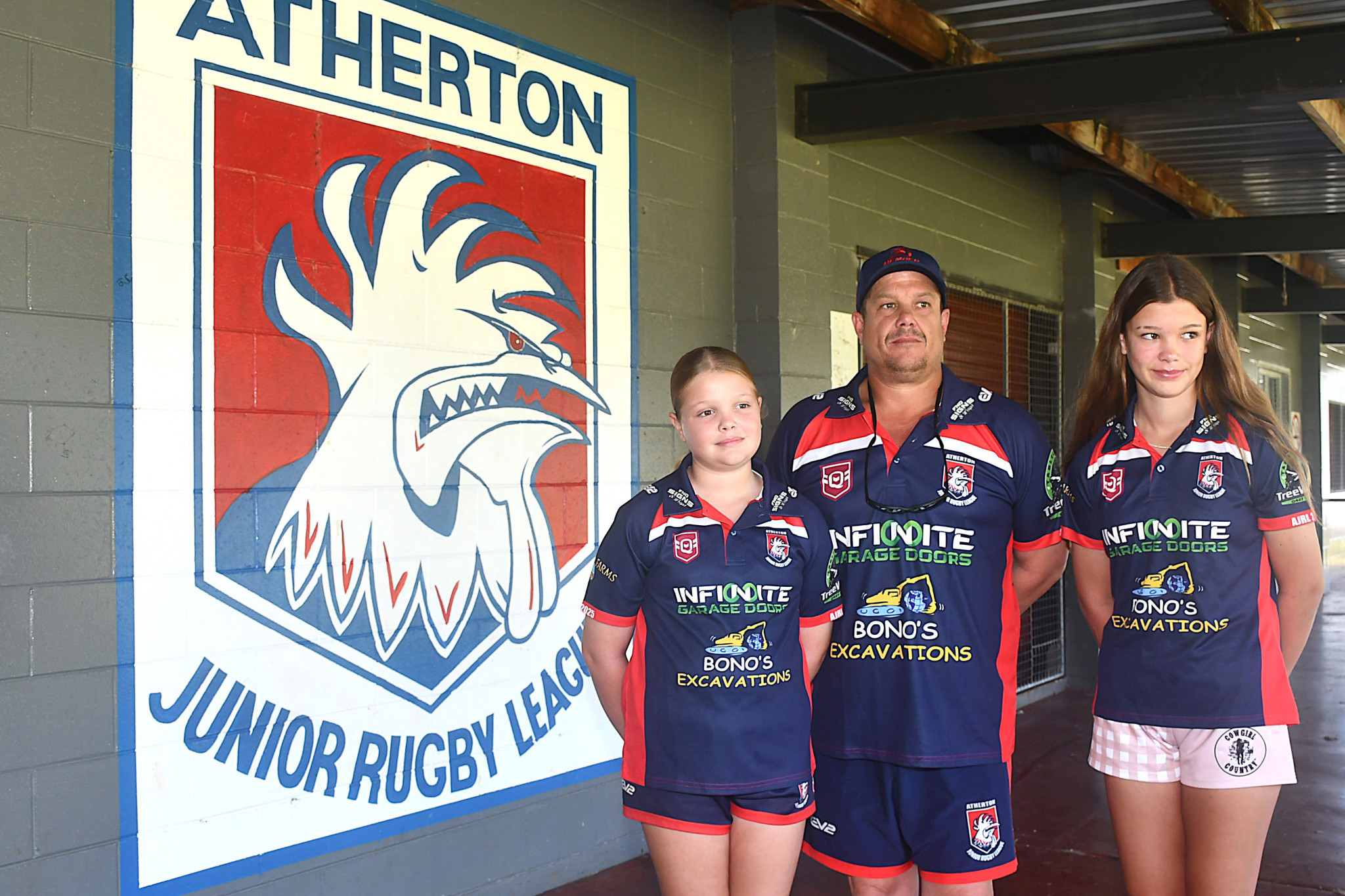Atherton Junior Rugby League president Wayde Kinder and his daughters, Indi and Aleia, who both play junior league, outside the clubhouse.