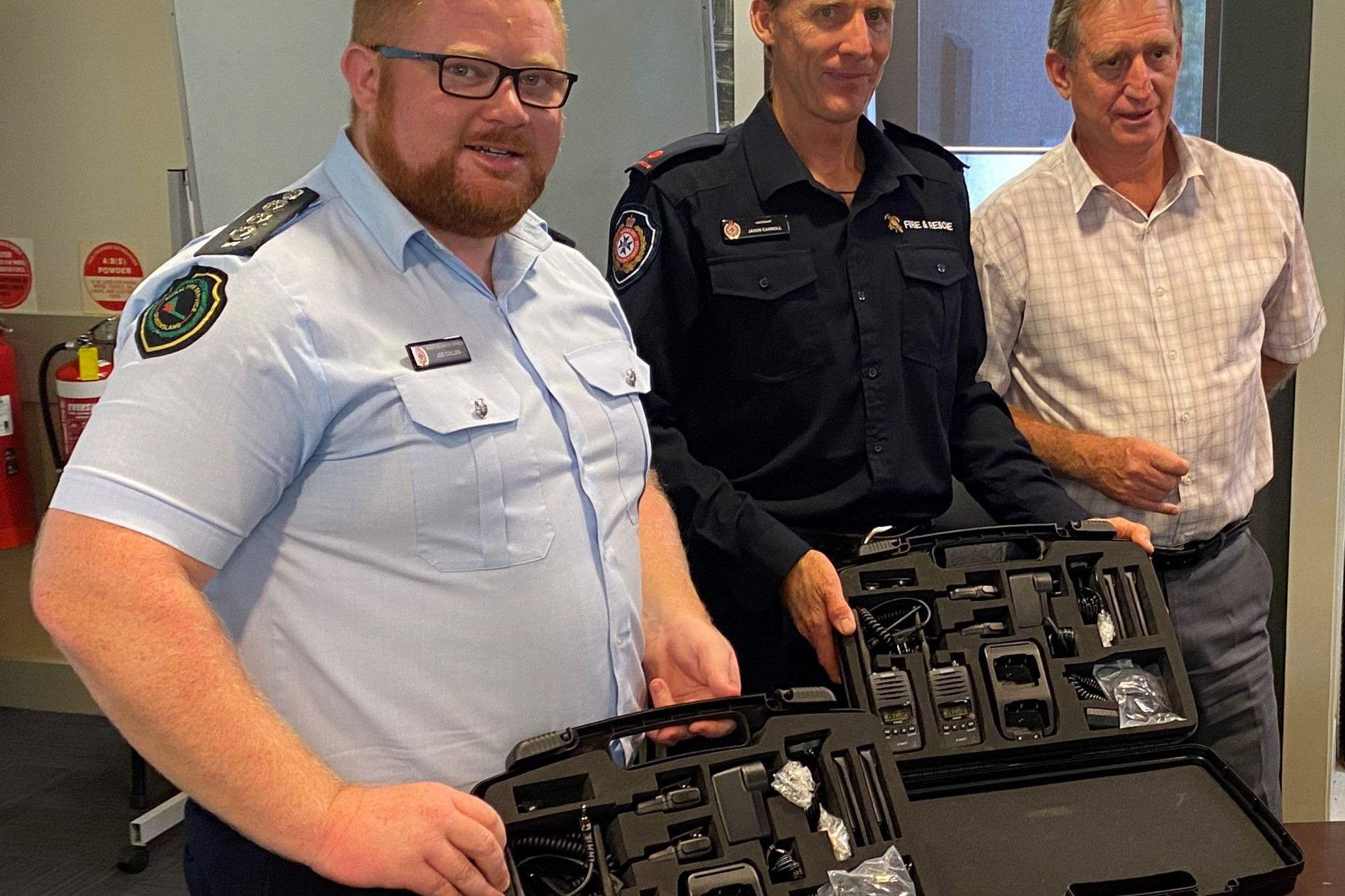 PICTURED: Joe Cullen, Acting Inspector, Area Director of Cairns Peninsular Area Rural Fire Service, and Jason Carroll Captain of the Cooktown Auxiliary Fire Brigade was presented the new radios by Cook Shire Mayor Peter Scott last week.