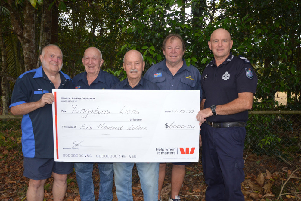 Vince Whaley, John Compton, Spencer Digby, Greg Lamborn and Sgt Greg Lee with the $6,000 cheque which will go towards the Yungaburra Lions medical equipment service.