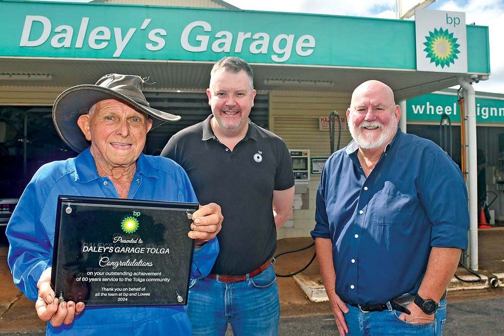 For the 60 years he has spent at his BP service station in Tolga, Dick Daley was presented with a special plaque by Keith Joyce from BP and Bernie Morris from Lowes Petroleum (right).