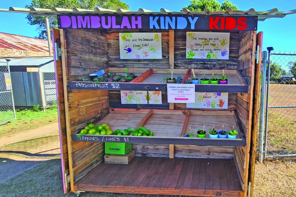 The Dimbulah Community Kindy has set up its fresh produce stall in front of Camp 64 Cafe.