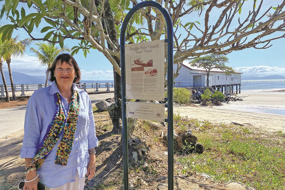 Douglas Shire Historical Society member Pam Willis Burden with one of the new photo posts have been installed at special locations in Port Douglas.